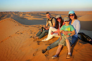 Famille de touristes sur une dune dans le désert du Wahiba.